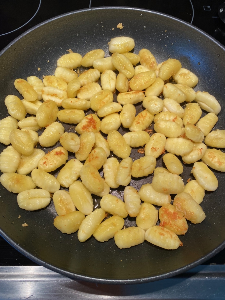 gnocchi cooking in a pan