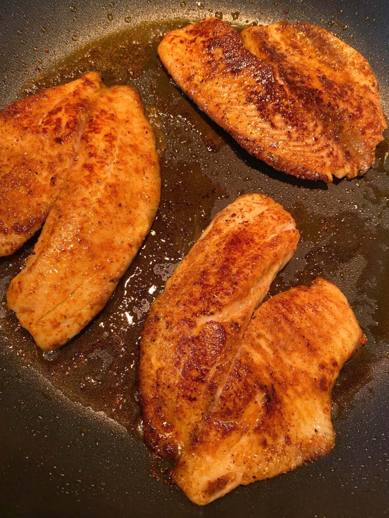 tilapia in frying pan