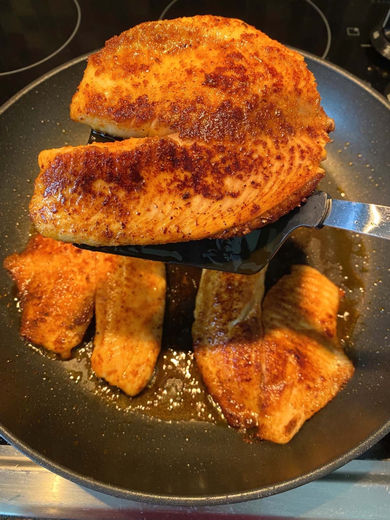 spatula holding Pan Fried Tilapia