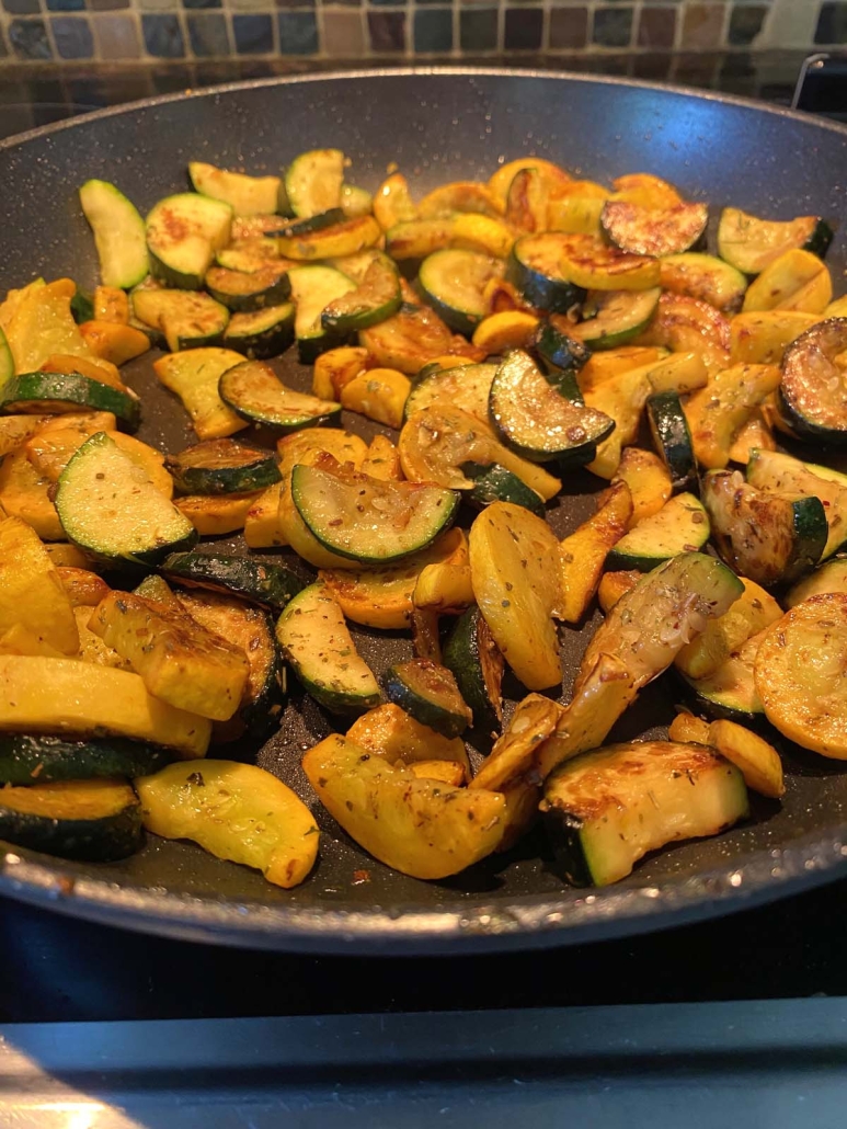 Sautéed Zucchini And Squash sizzling in a skillet