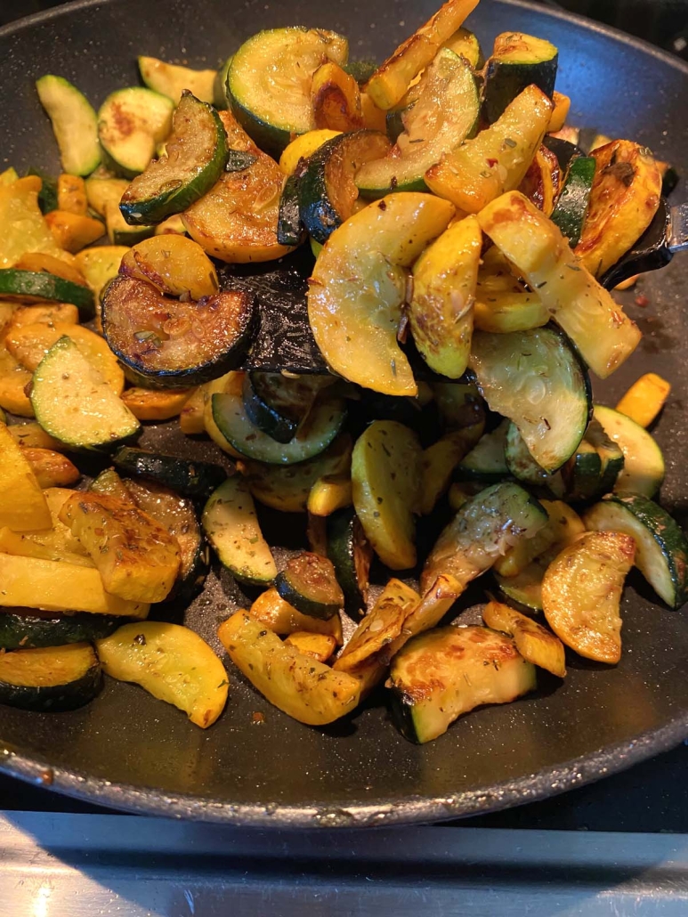 Sautéed Zucchini And Squash cooking in a skillet