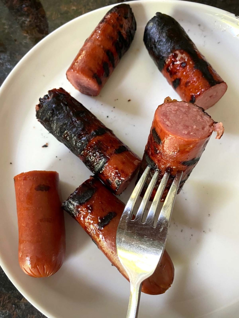 fork holding piece of Grilled Kielbasa Polish Sausage