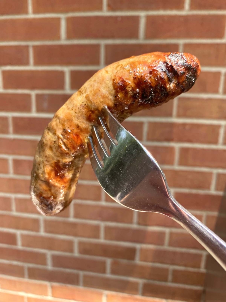 fork holding cooked Italian Sausage