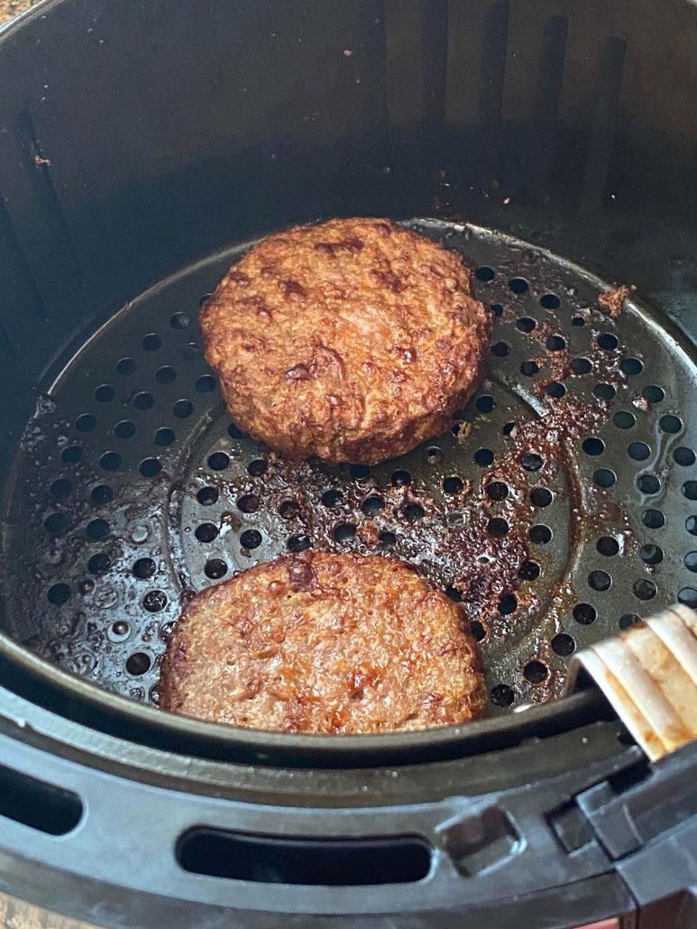 Beyond Burgers cooking in air fryer basket