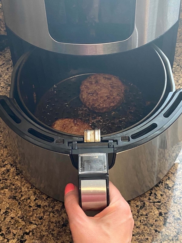 air fryer opened to show cooking Beyond Burgers