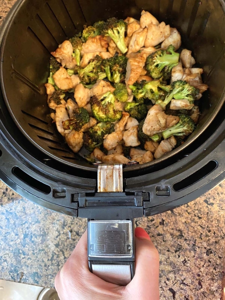 seasoned chicken and broccoli in air fryer basket