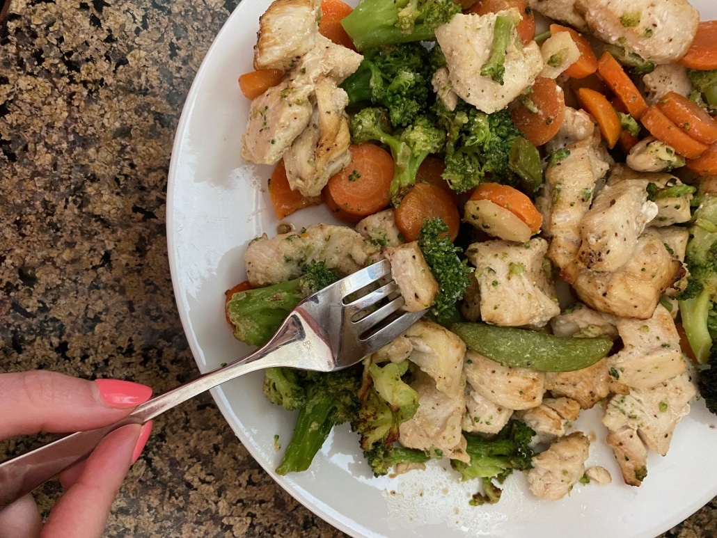 fork picking up piece of Air Fryer Chicken And Frozen Vegetables