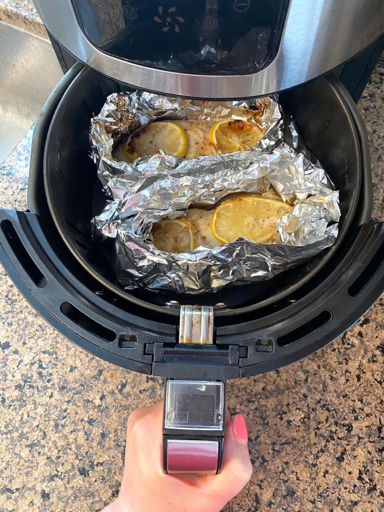 air fryer opened to show chicken breast inside