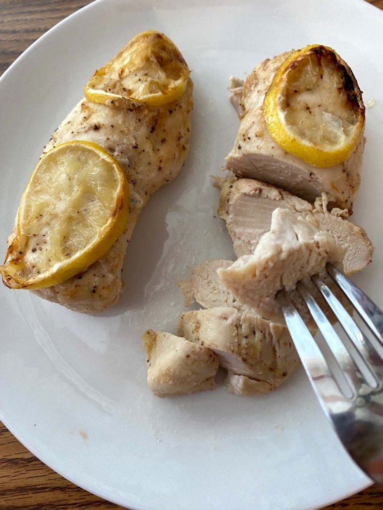 forking holding piece of cooked, seasoned chicken breast