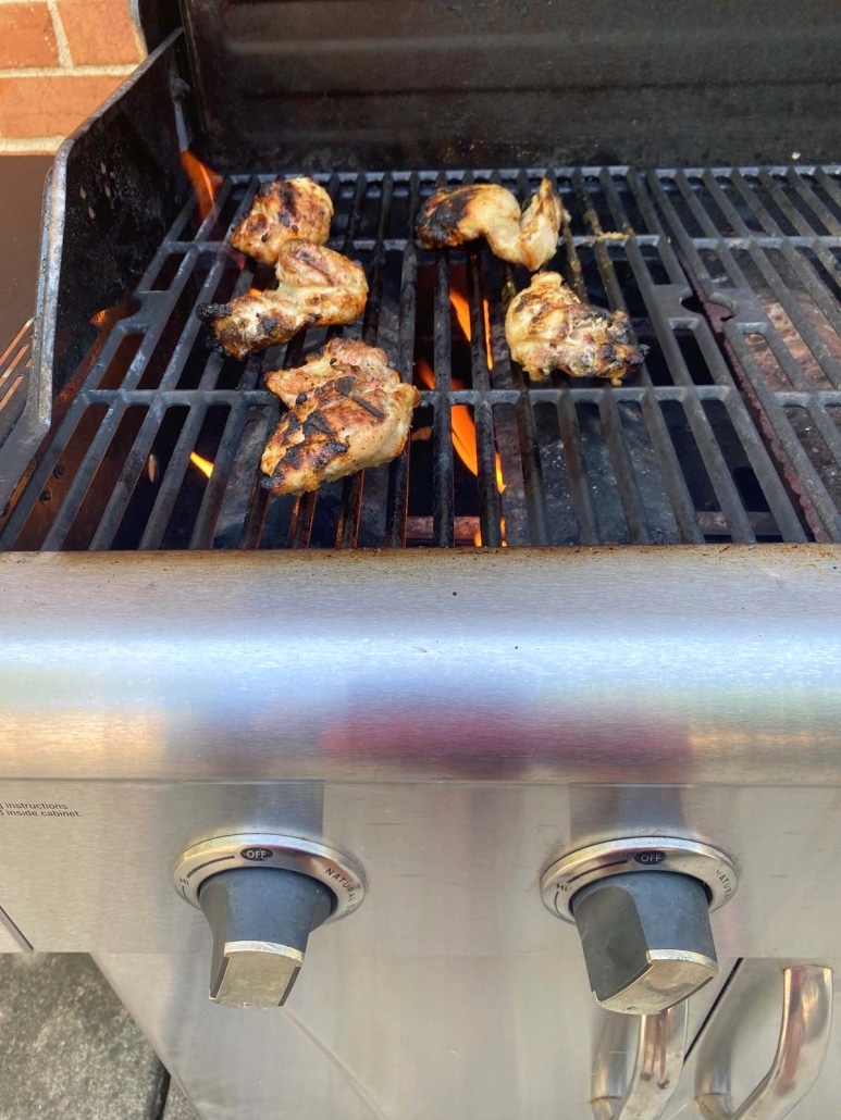 grilling seasoned chicken thighs