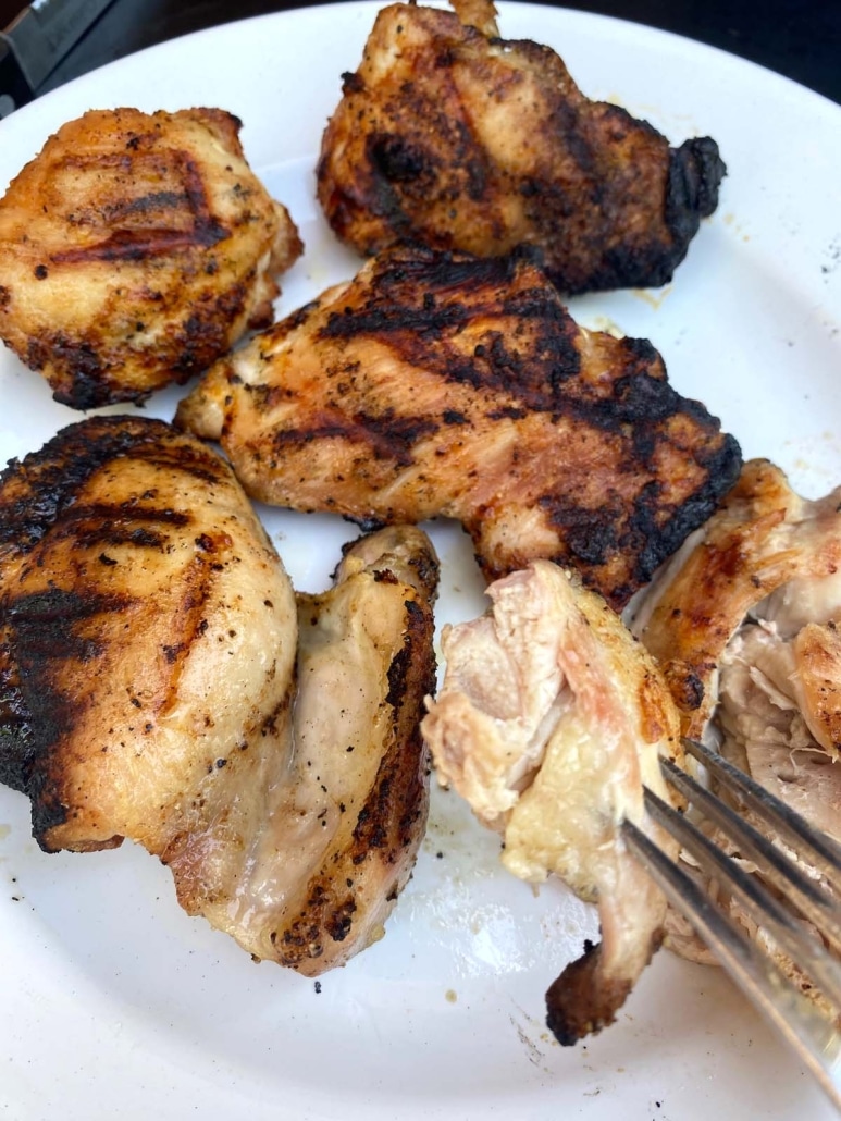 fork holding piece of Grilled Boneless Chicken Thighs