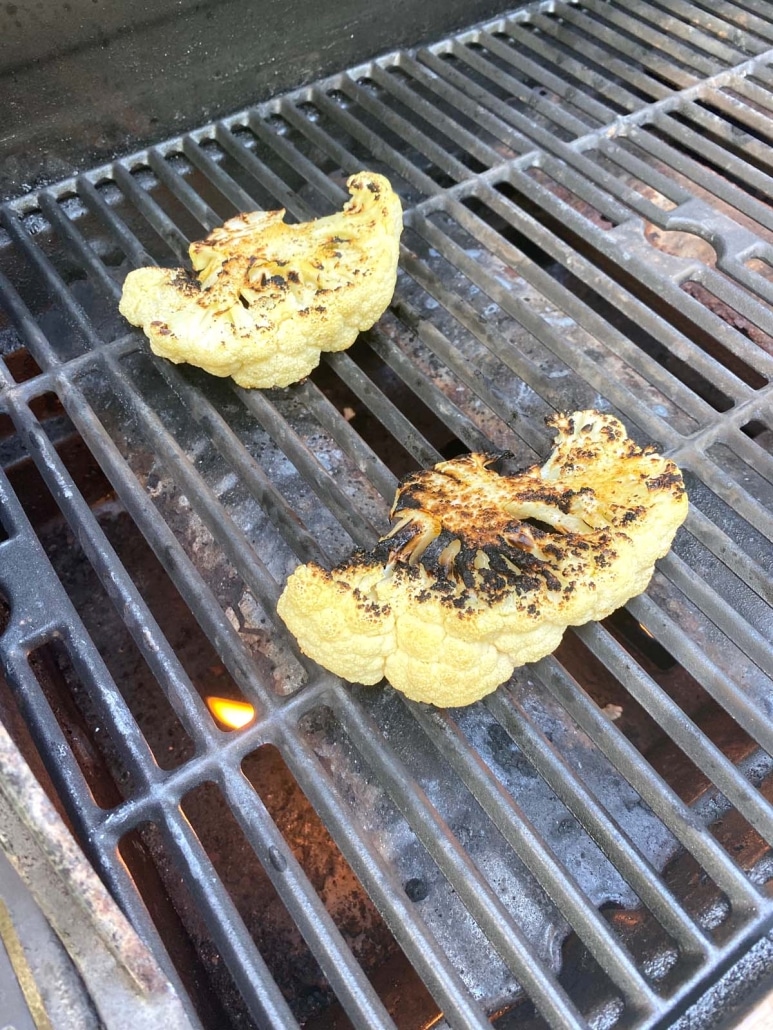 cauliflower steaks cooking on the grill 