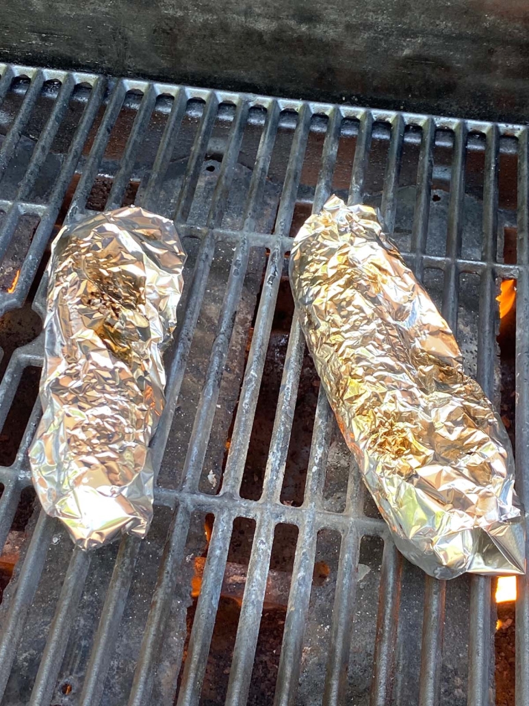 seasoned corn in foil on grill