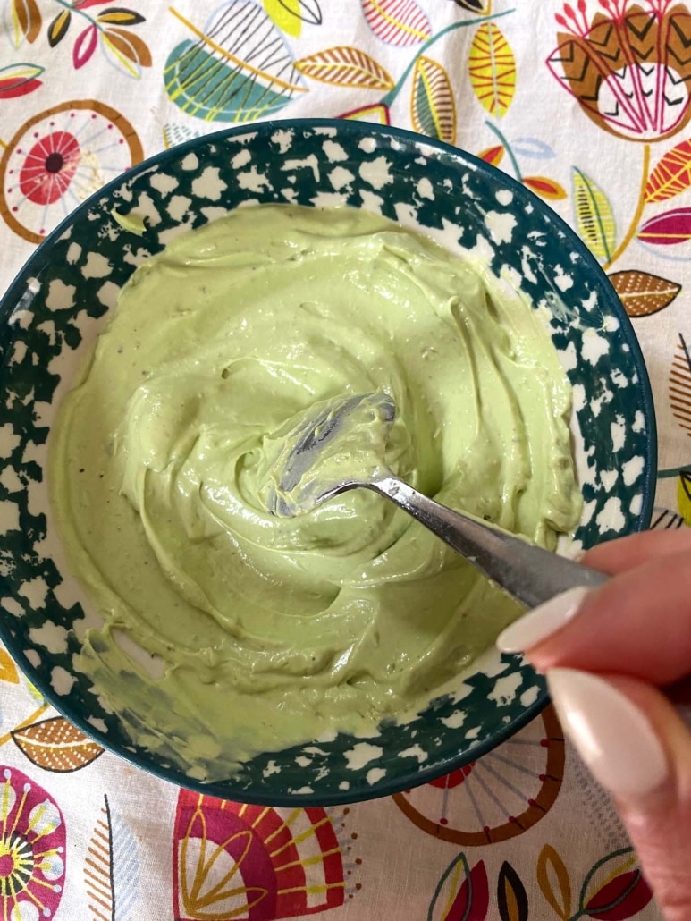 spoon stirring up Avocado Crema