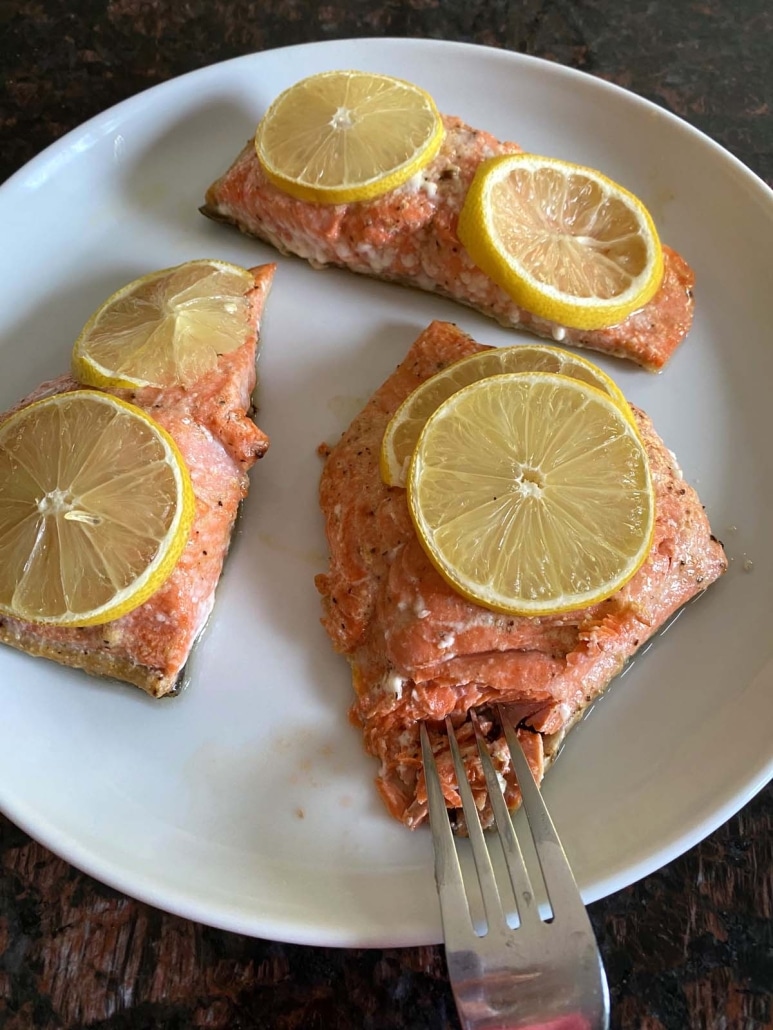 fork flaking off a piece of Baked Sockeye Salmon