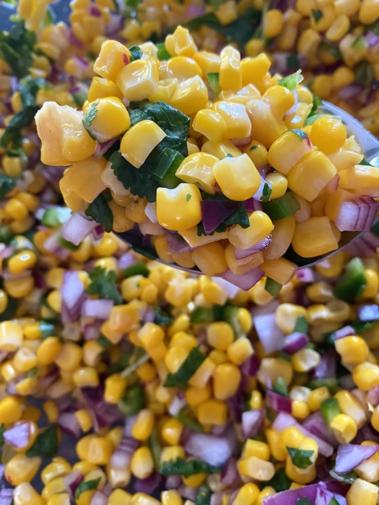 spoon filled with Chipotle Corn Salsa Copycat Recipe