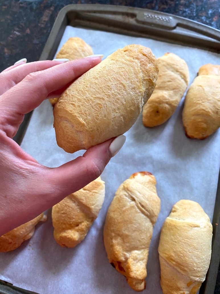 hand holding appetizer Pizza Crescent Roll