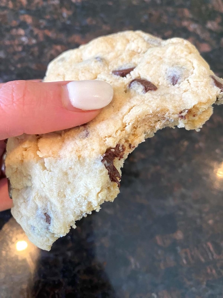 hand holding Microwave Chocolate Chip Cookie with bite taken out