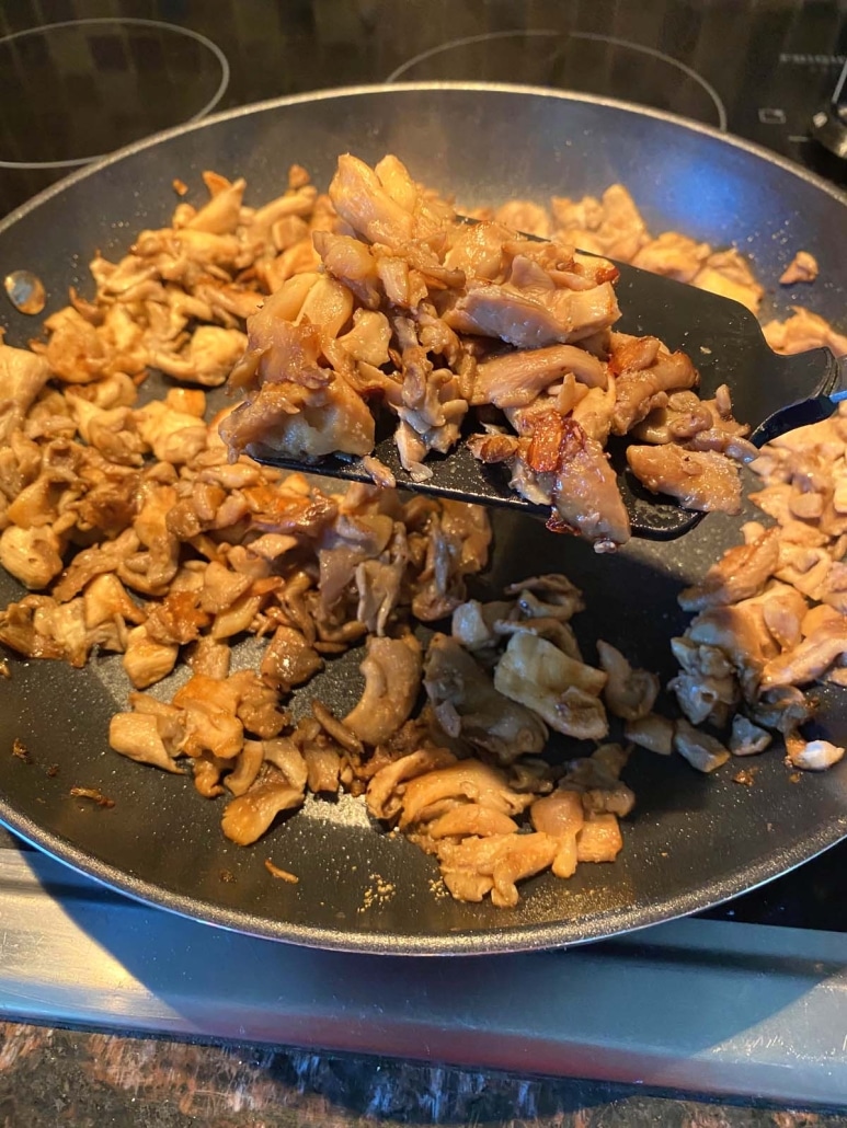 spatula stirring up cooked oyster mushrooms