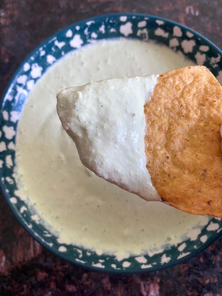 green onion dip on a tortilla chip