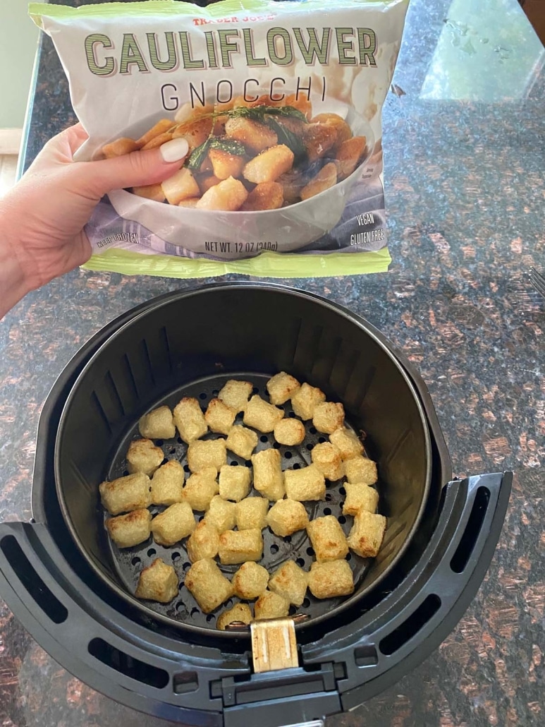 package of Trader Joe’s Cauliflower Gnocchi above cooked gnocchi in air fryer