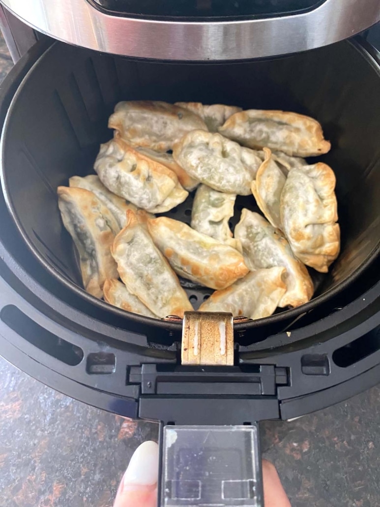 air fryer opened to show Trader Joe's Gyoza cooking inside