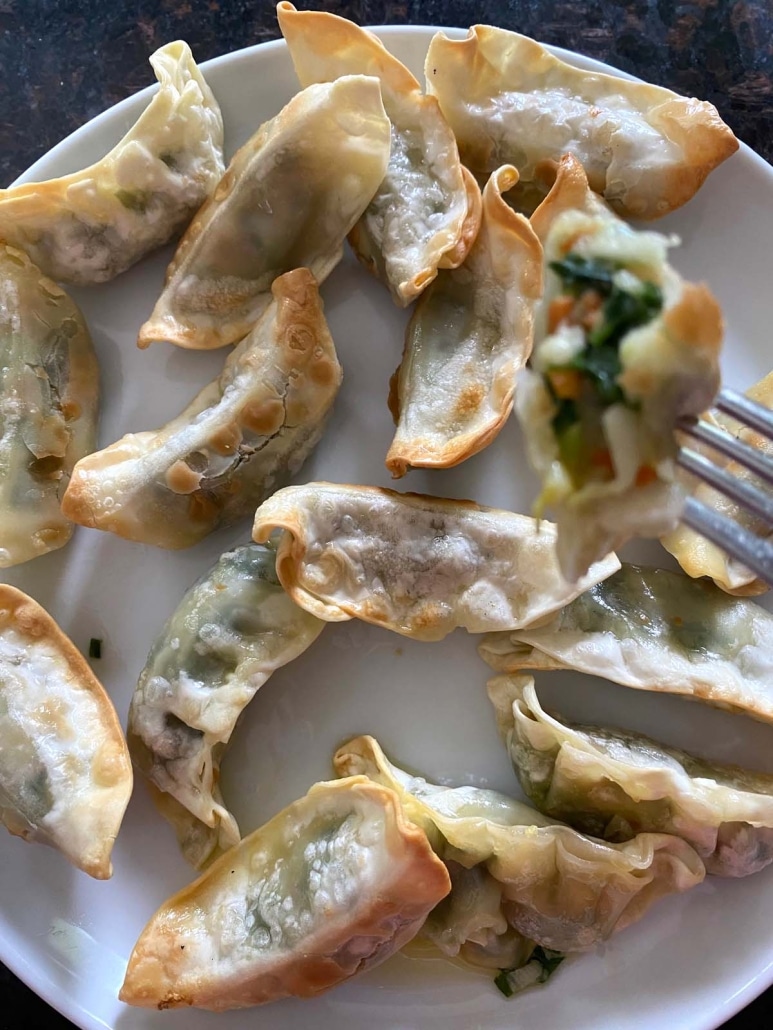 fork holding sliced open gyoza