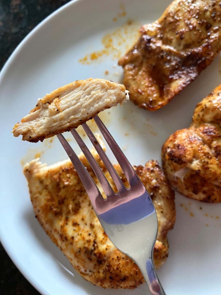 fork holding piece of Air Fryer Thin Sliced Chicken Breast