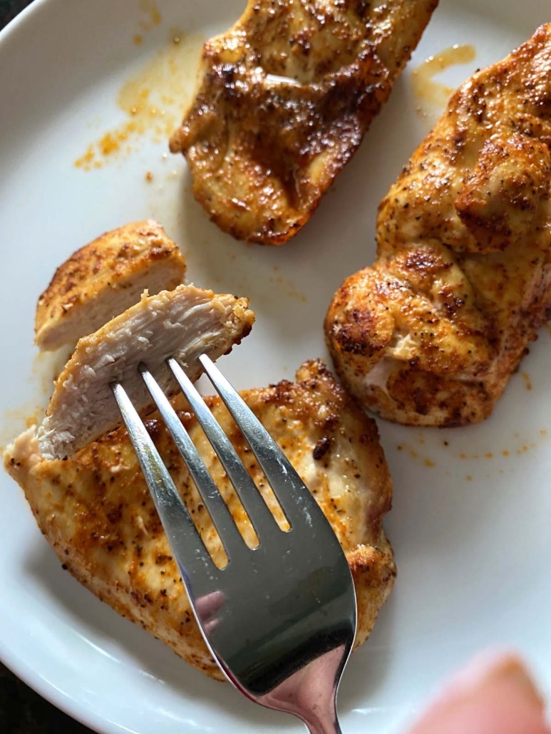 Air Fryer Thin Sliced Chicken Breasts cut into pieces on a plate