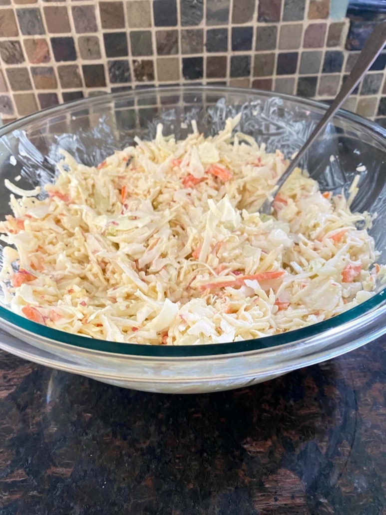 mixing up shredded ingredients of Apple Coleslaw