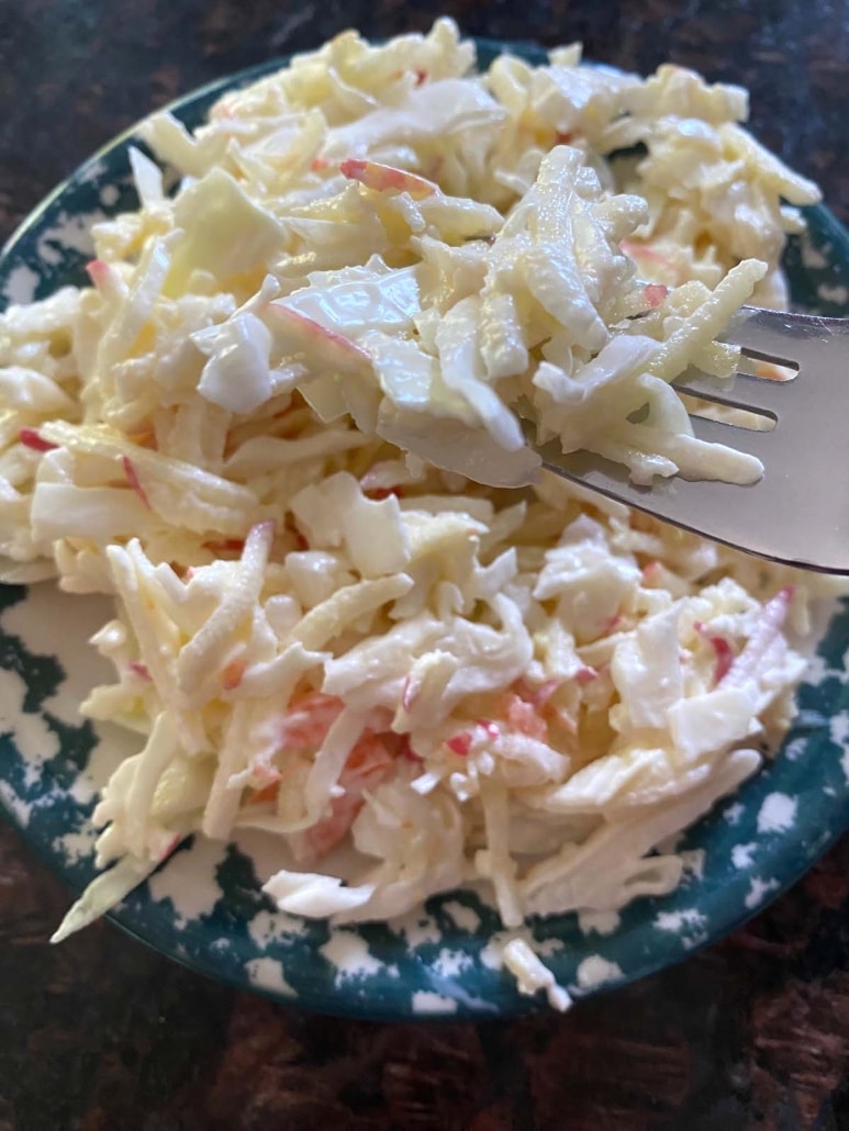 fork grabbing bite of Apple Coleslaw