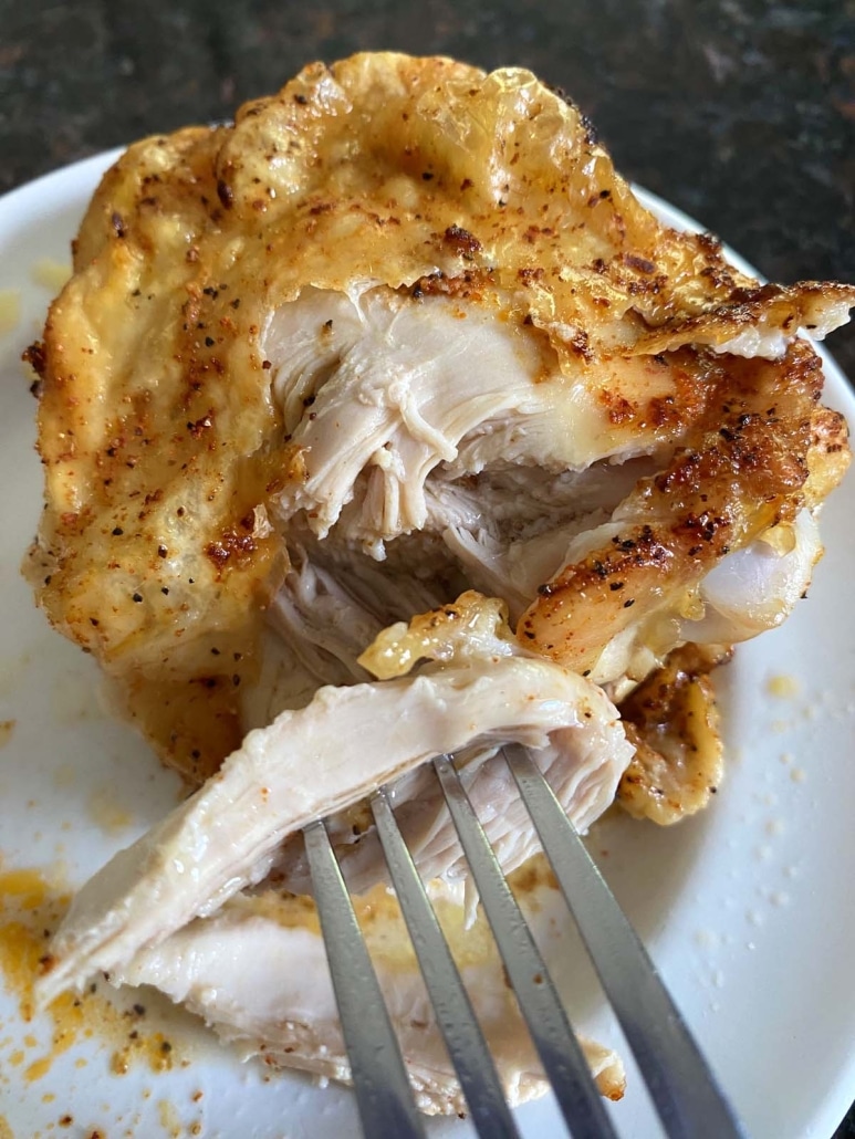 fork in piece of Baked Bone-In Chicken Thigh