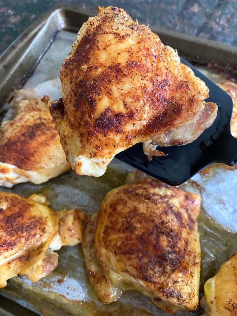 spatula holding Baked Bone-In Chicken Thigh