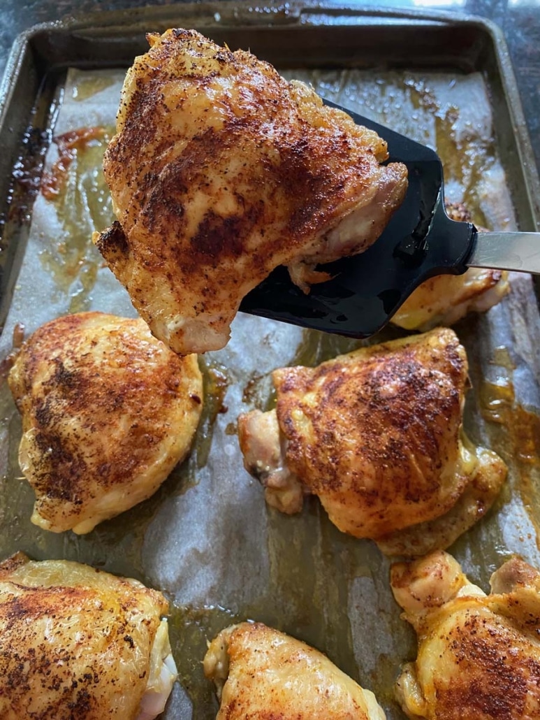 spatula picking up seasoned Bone-In Chicken Thigh