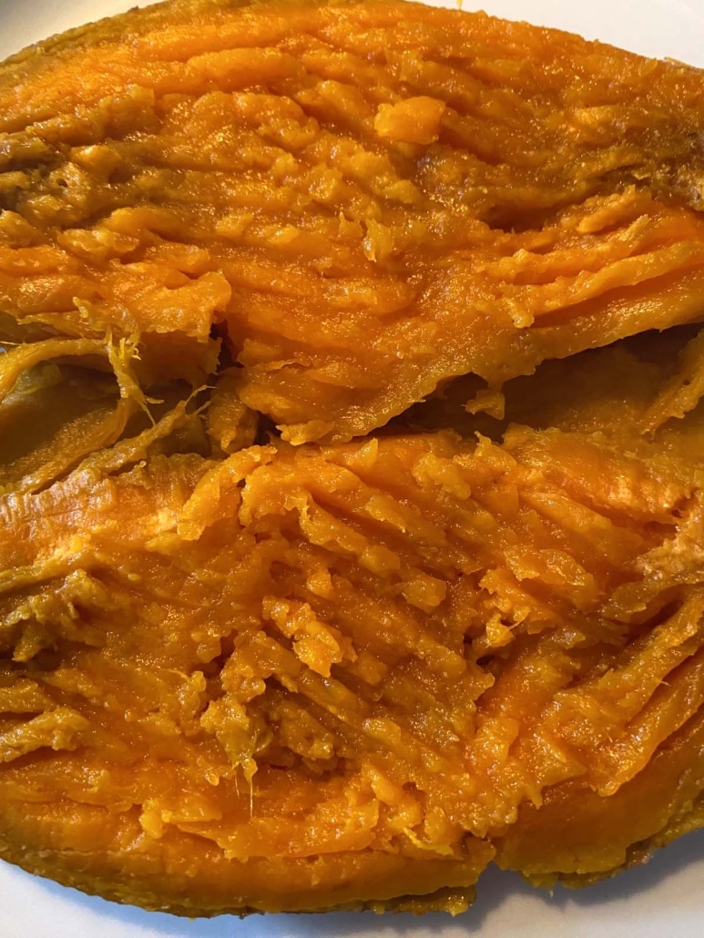 cooked whole sweet potato sliced open and mashed