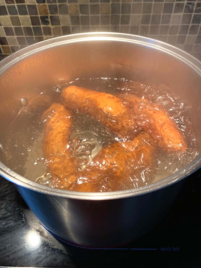 big pot of boiling water with sweet potatoes inside