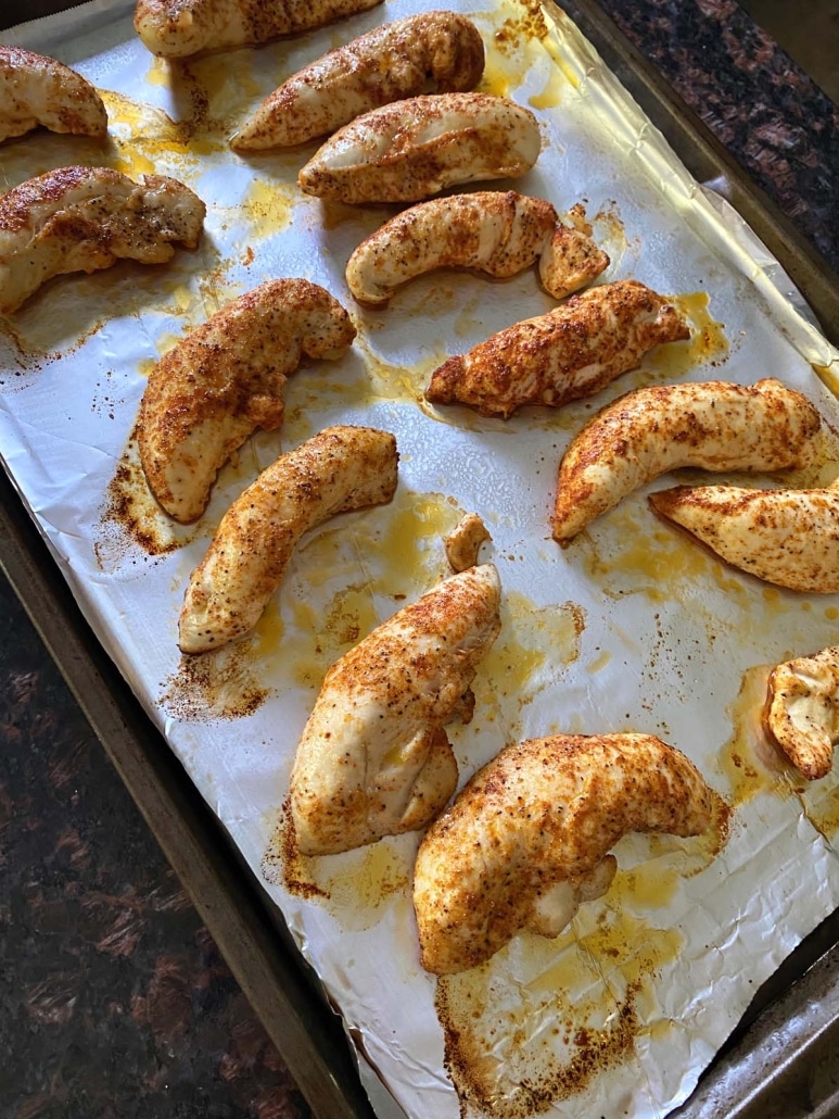 low carb and keto-friendly, broiled chicken tenders on a baking sheet