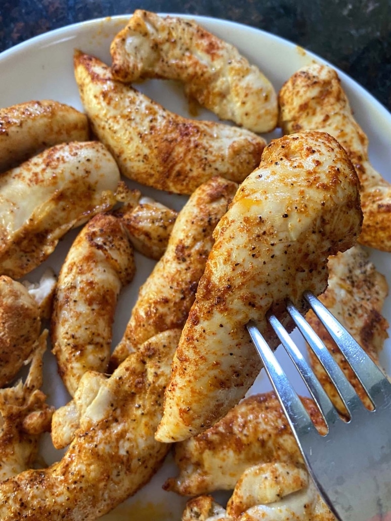 fork holding a broiled chicken tender