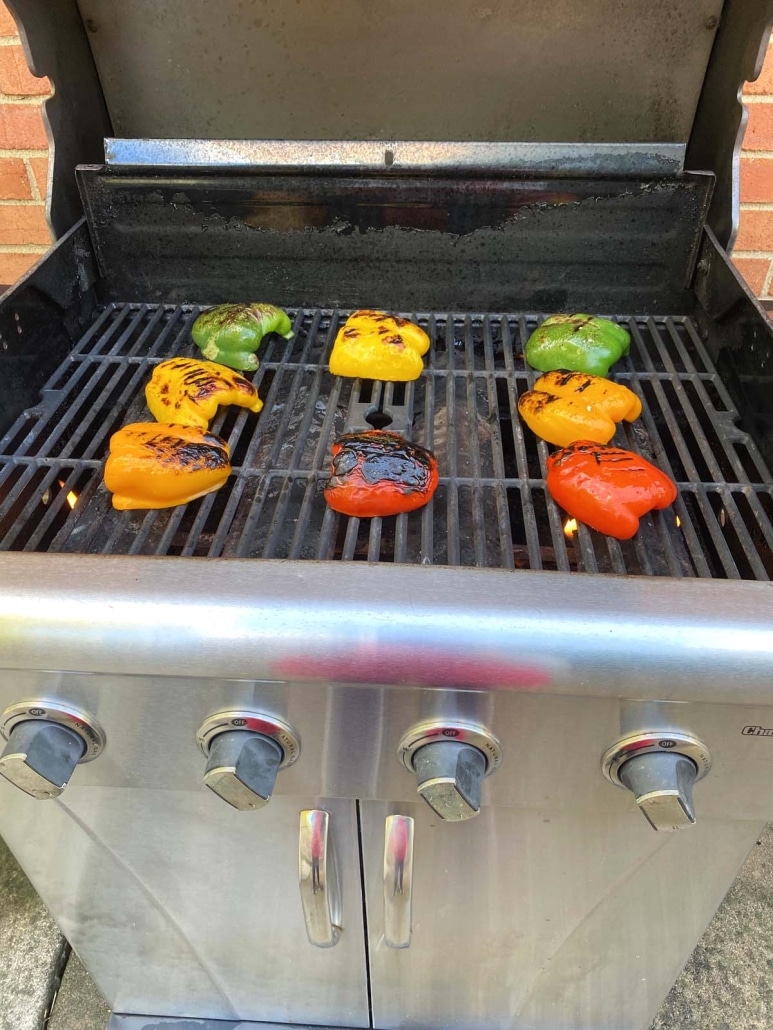 front of grill with bell peppers cooking inside