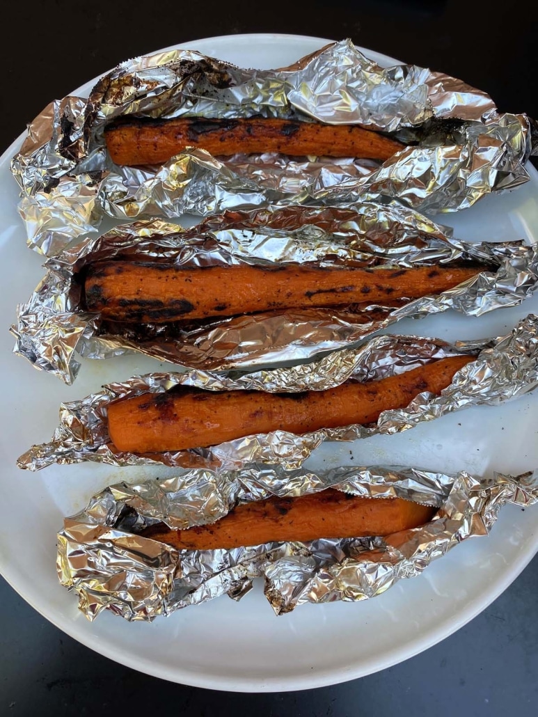 Grilled Carrots in foil wrappers on plate