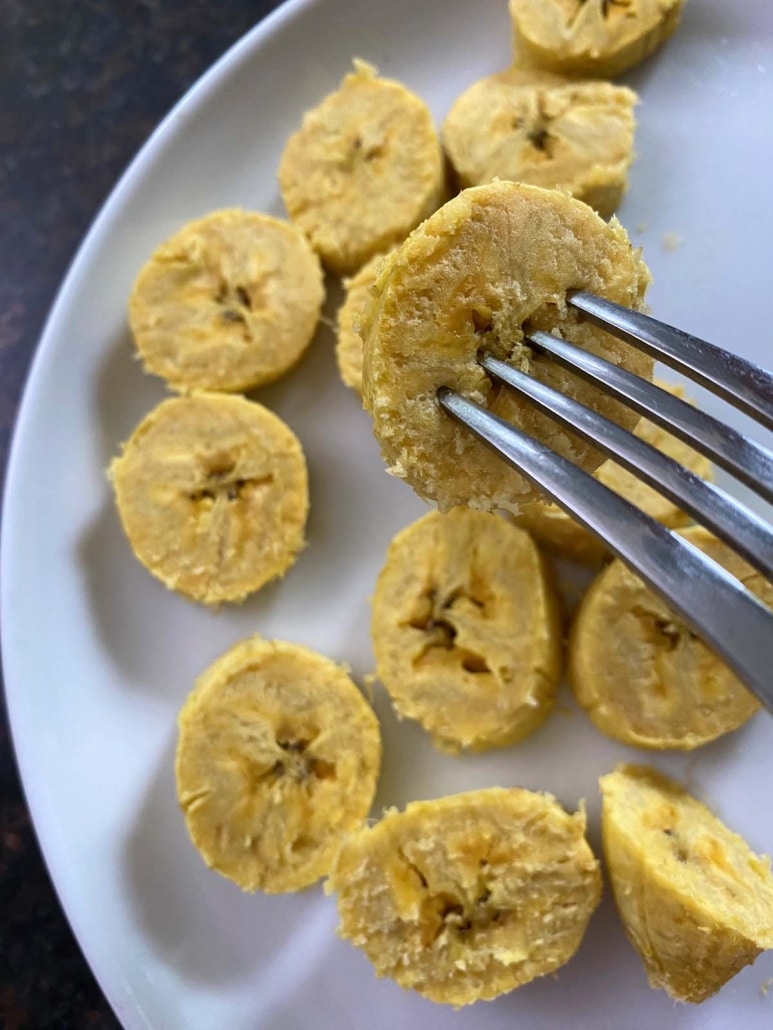 fork holding slice of perfectly cooked microwaved plantain