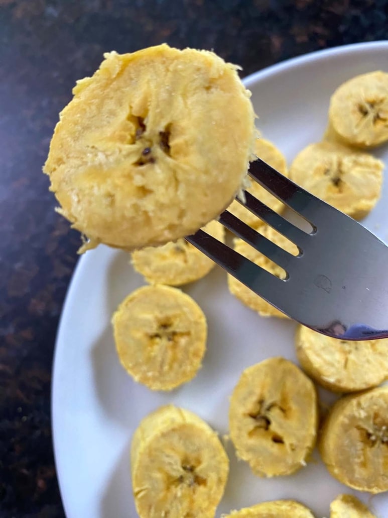 fork holding slice of cooked plantain