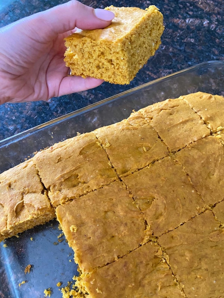 hand holding piece of fluffy pumpkin cake