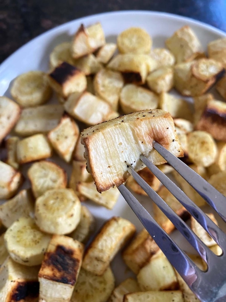 fork holding piece of Roasted Parsnip