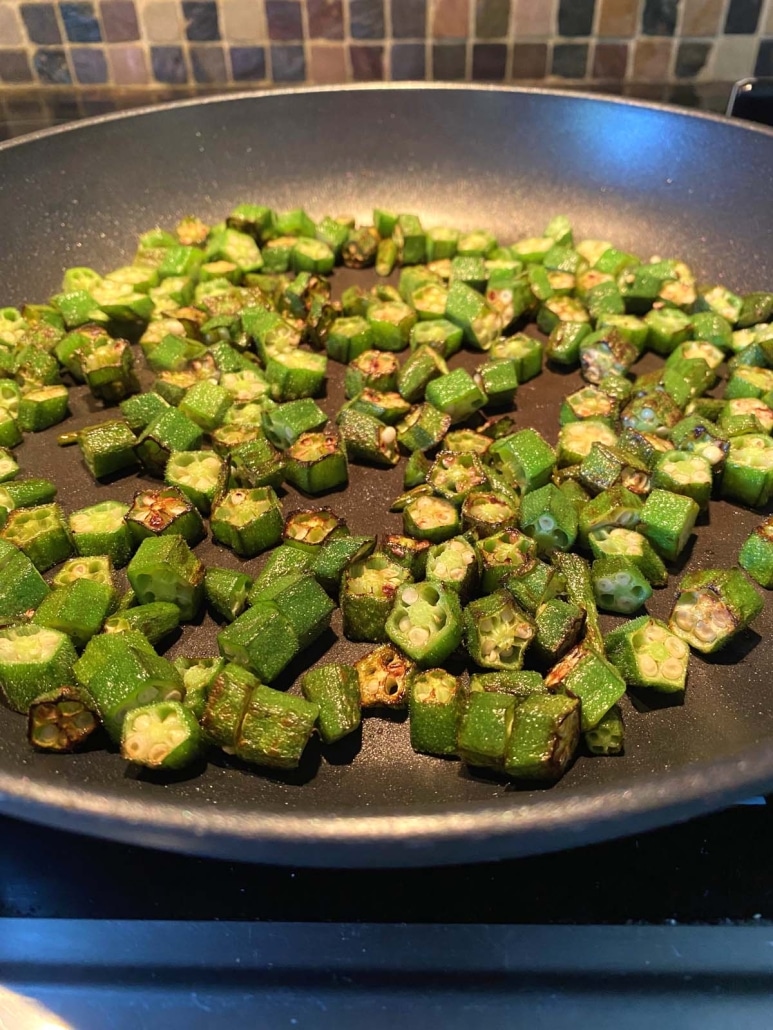 fresh okra sautéing in a pan