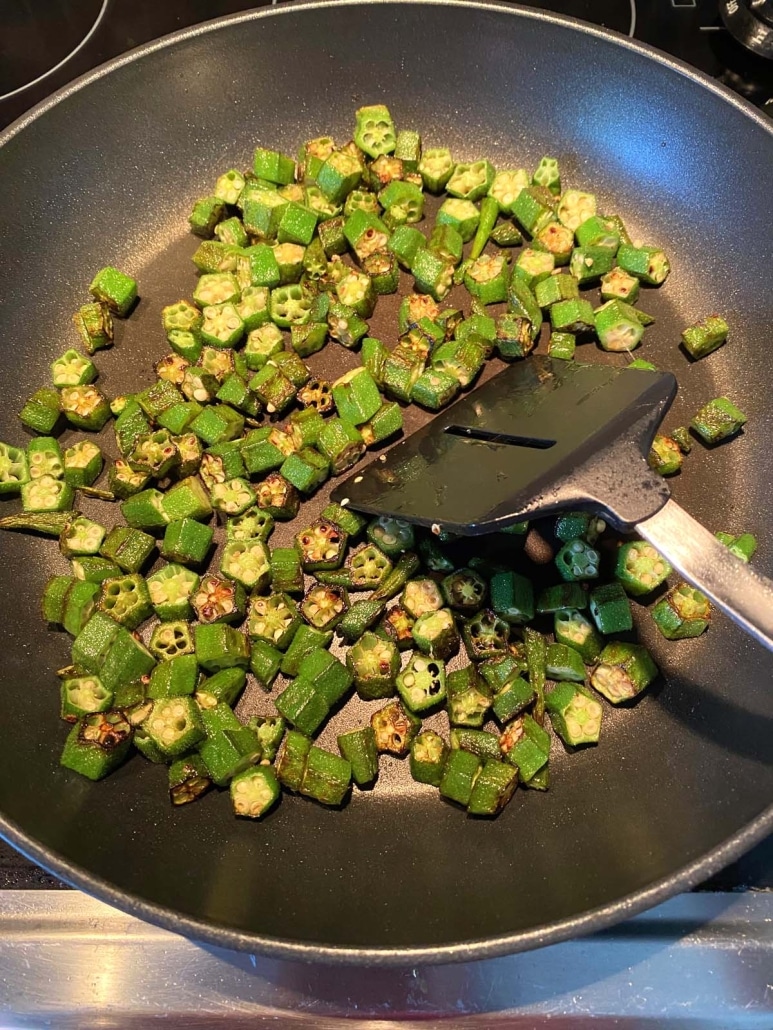 sautéing okra slices in a skillet