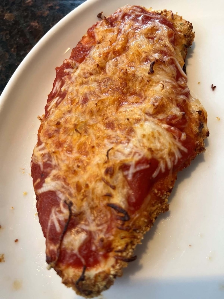 cooked chicken breast topped with breadcrumbs, marinara sauce, and cheese