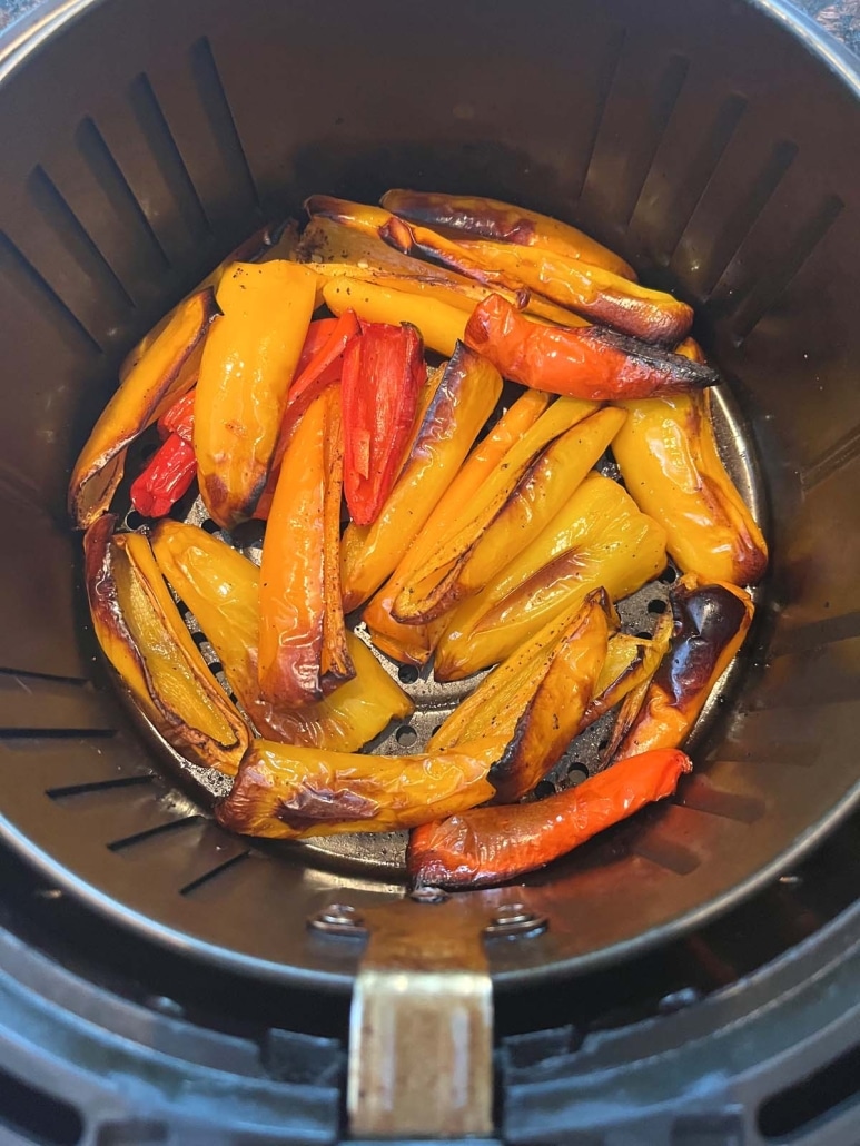 air fryer basket with mini peppers inside