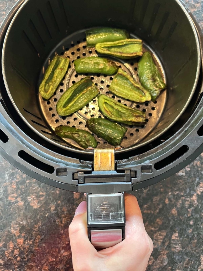 hand holding basket of Air Fryer Roasted Jalapeños