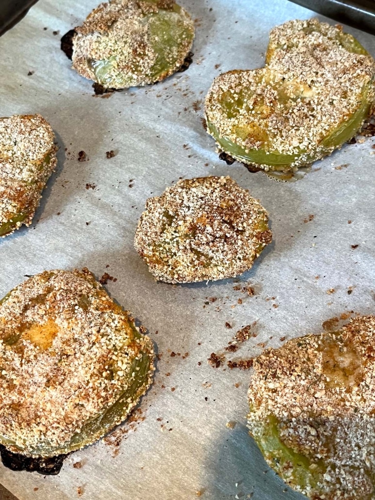 green tomato slices on a baking sheet